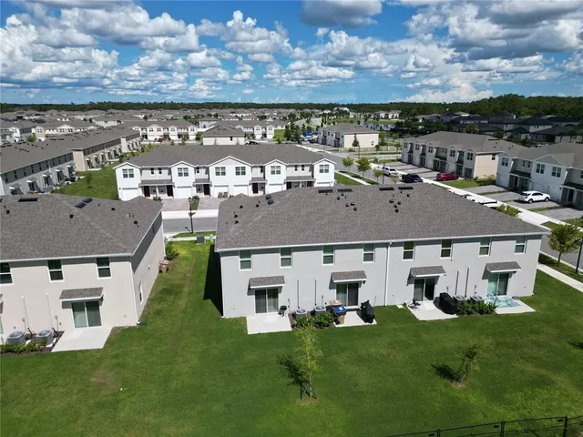 a aerial view of a house with a garden and a sitting space