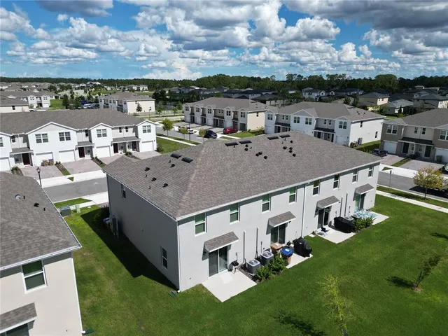 a aerial view of a house with a yard