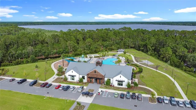 a view of a swimming pool with lawn chairs under an umbrella