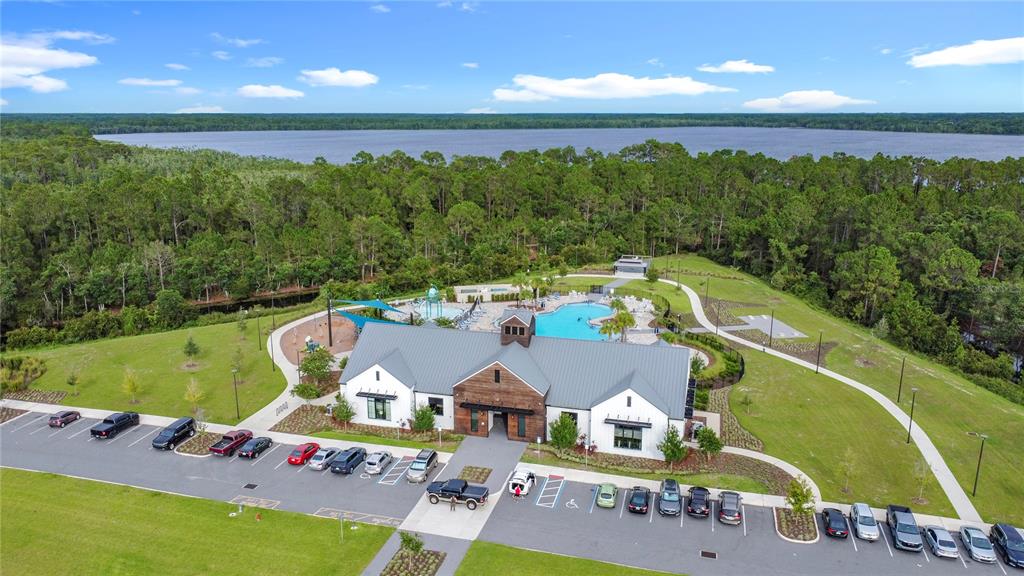 2914 Hudson Hammock Way St. Cloud, FL 34773 - Photo 8 of 30 a view of a swimming pool with lawn chairs under an umbrella