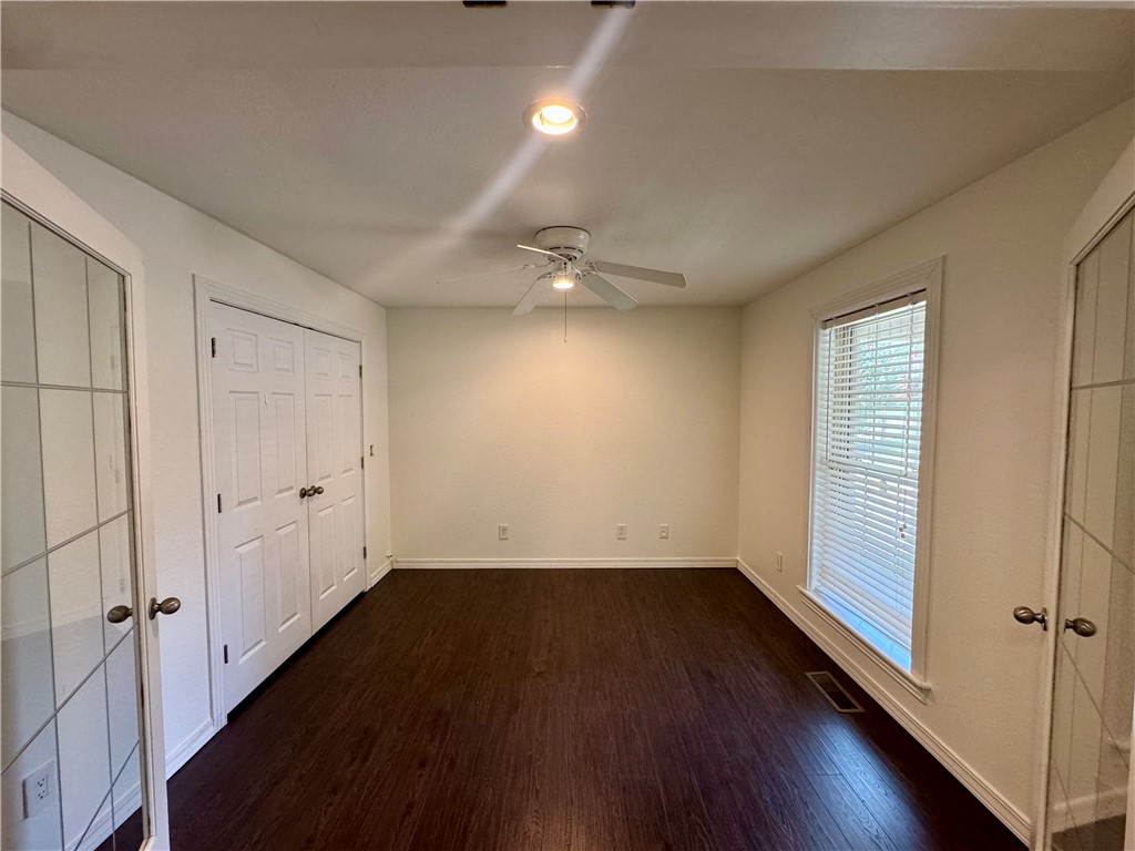 Room featuring wood-finish flooring, a ceiling fan, recessed lighting, and a window with blinds