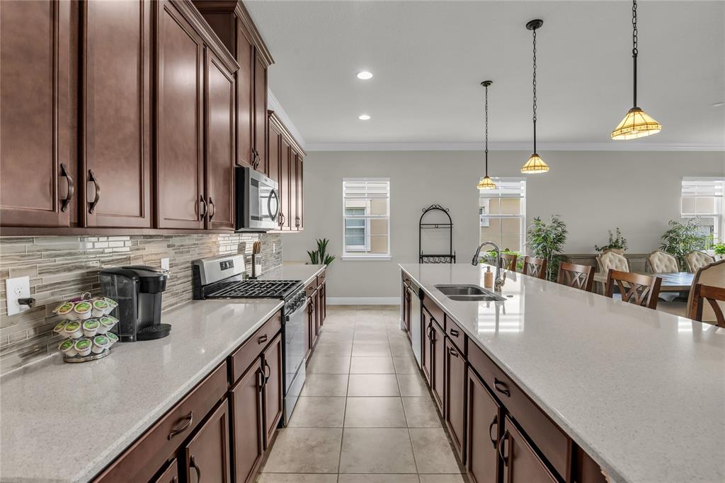 2665 Meadowedge Loop St. Cloud, FL 34772 - Photo 11 of 53 a kitchen with lots of counter space a sink appliances and cabinets