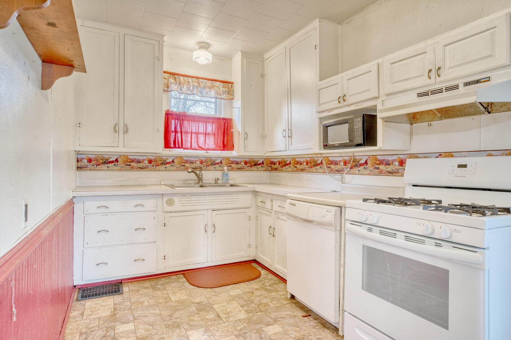 5790 West 700 South Morocco, IN 47963 - Photo 18 of 28 a kitchen with cabinets appliances a sink and a counter top