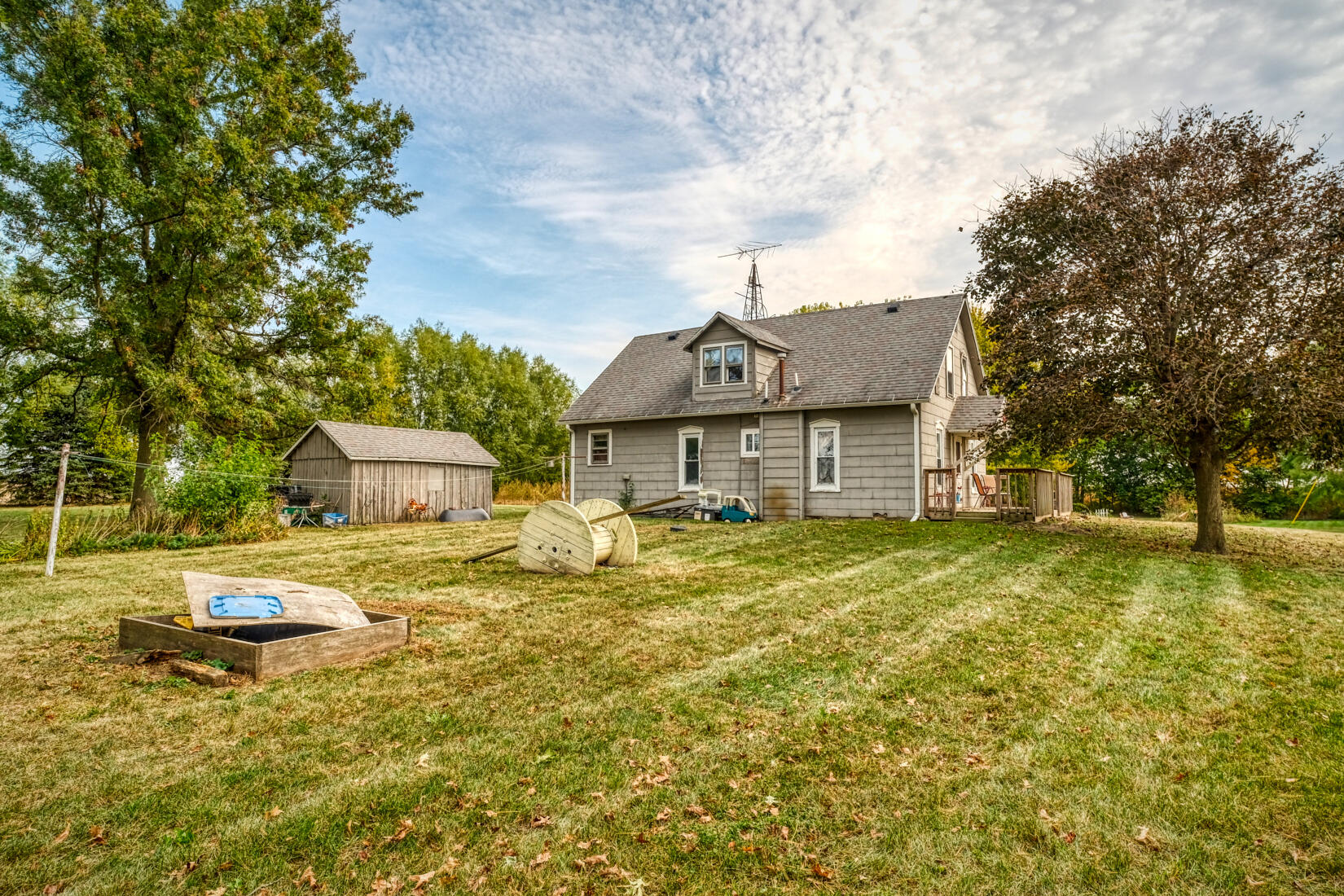 5790 West 700 South Morocco, IN 47963 - Photo 5 of 28 a backyard of a house with table and chairs under an umbrella