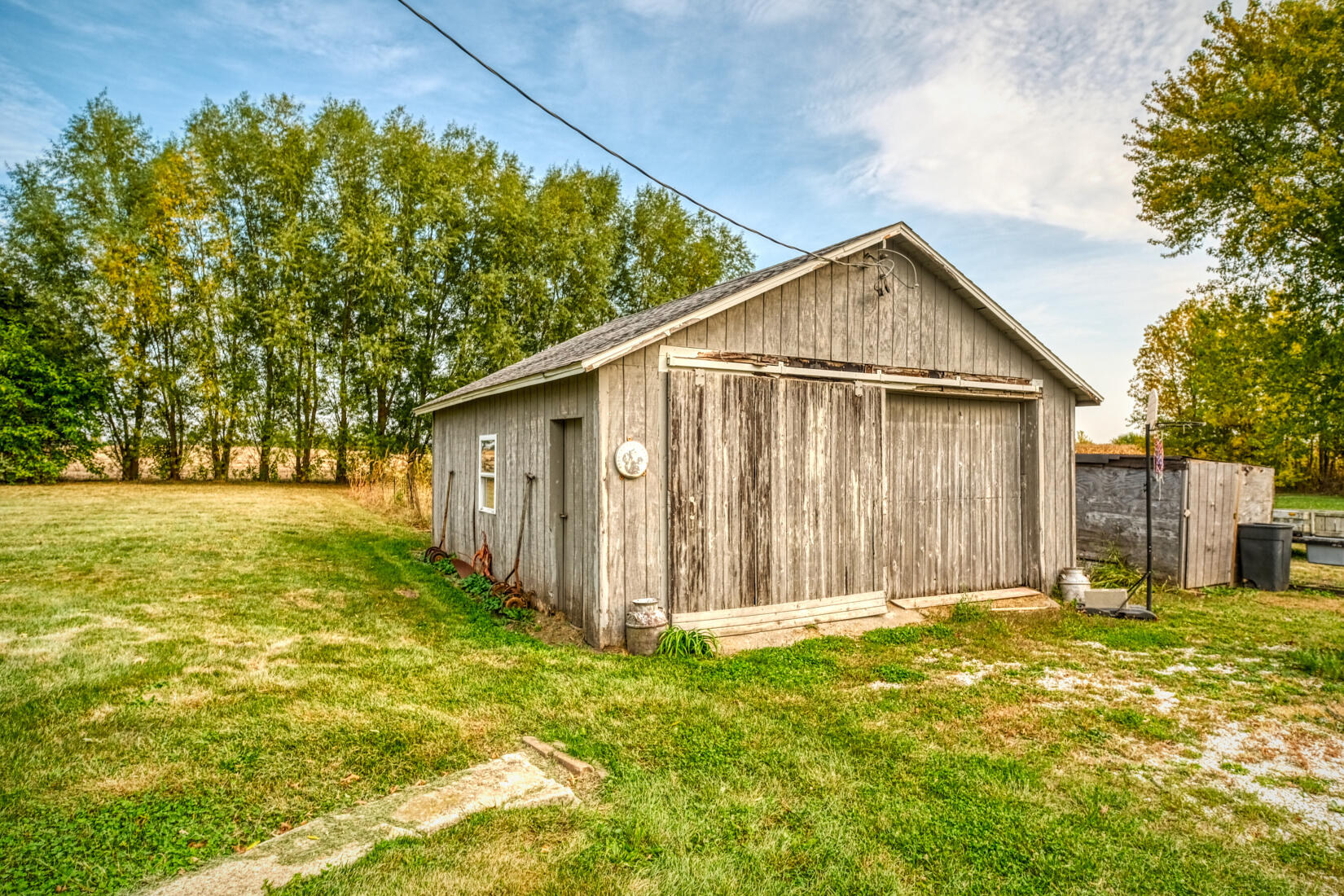 5790 West 700 South Morocco, IN 47963 - Photo 10 of 28 a view of a backyard with large trees and wooden fence