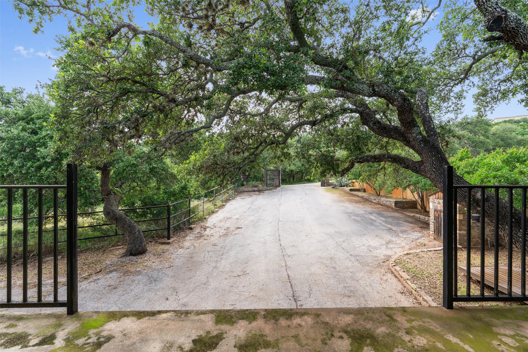 325 Eagle Rest Burnet, TX 78611 - Photo 39 of 40 Secure entry via a private drive framed by mature trees, leading to a stately property.