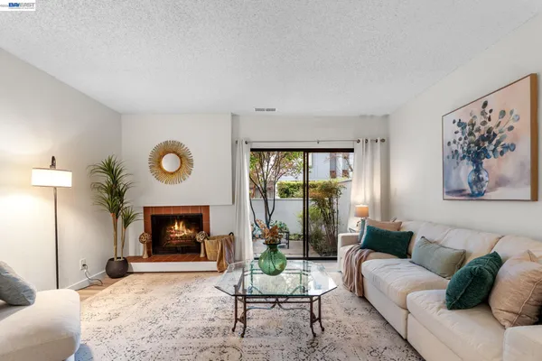 a living room with furniture flat screen tv and a fireplace