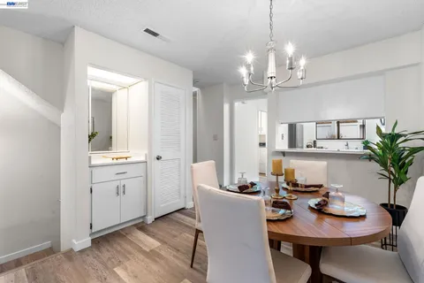a view of a dining room with furniture and chandelier