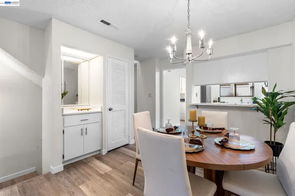 a view of a dining room with furniture and chandelier