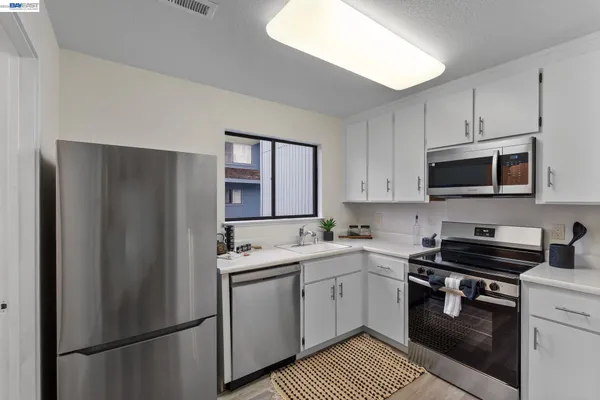 a kitchen with a refrigerator stove and sink