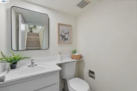 a bathroom with a toilet a sink and mirror
