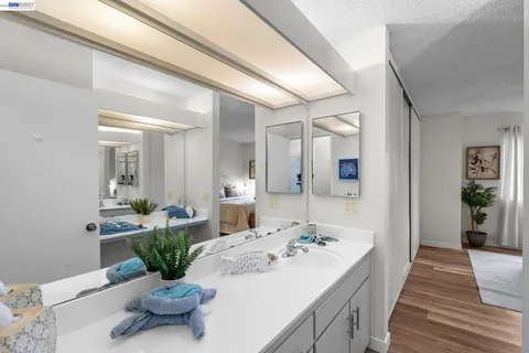 a room with a sink and wooden floor