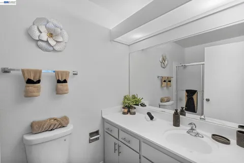 a bathroom with a sink a toilet and mirror