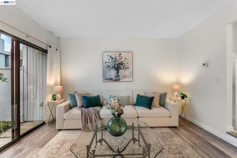 a living room with furniture and white walls