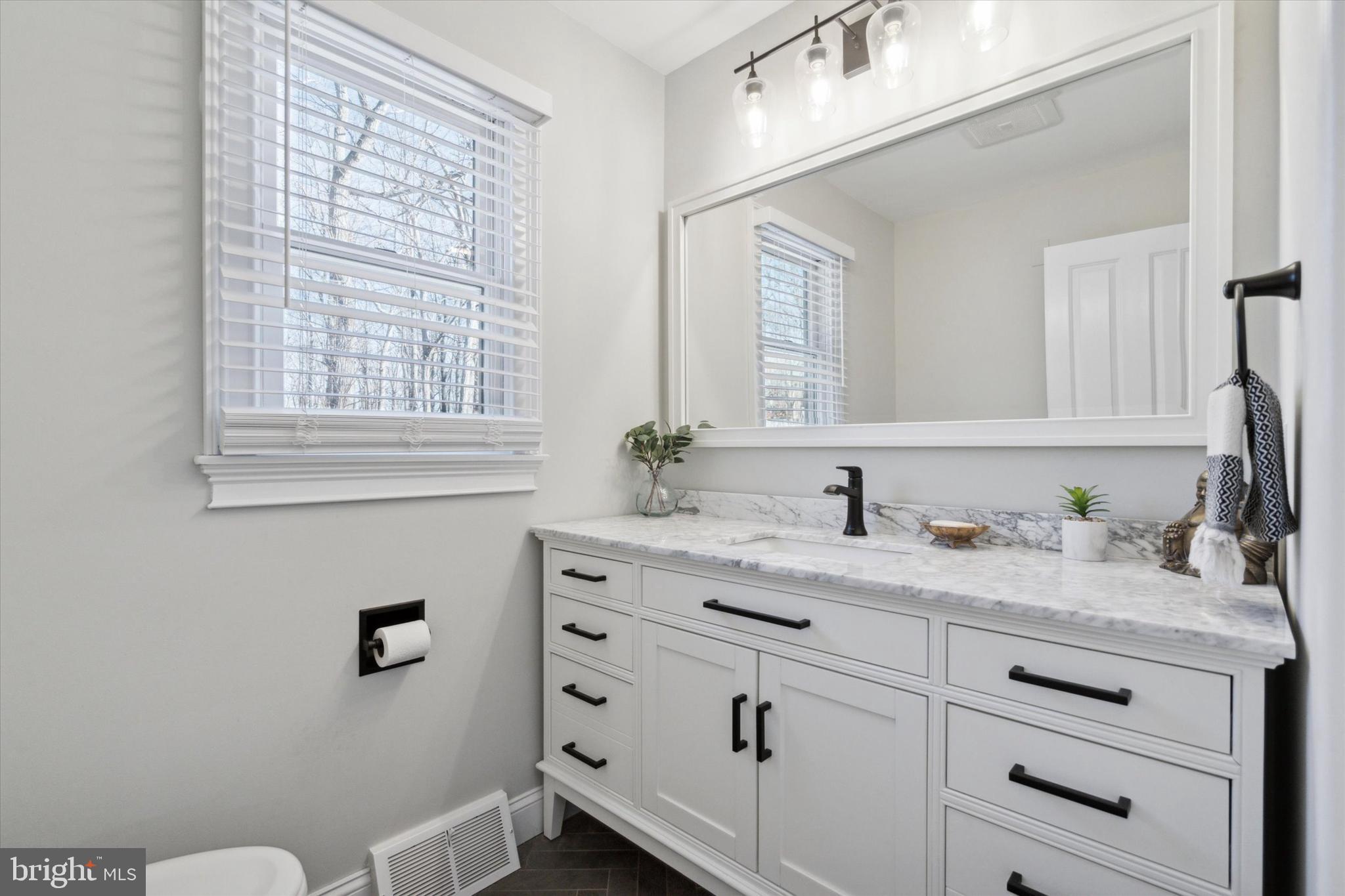 132 Hawkin Road New Egypt, NJ 08533 - Photo 16 of 42 a bathroom with a granite countertop sink vanity mirror next to a window