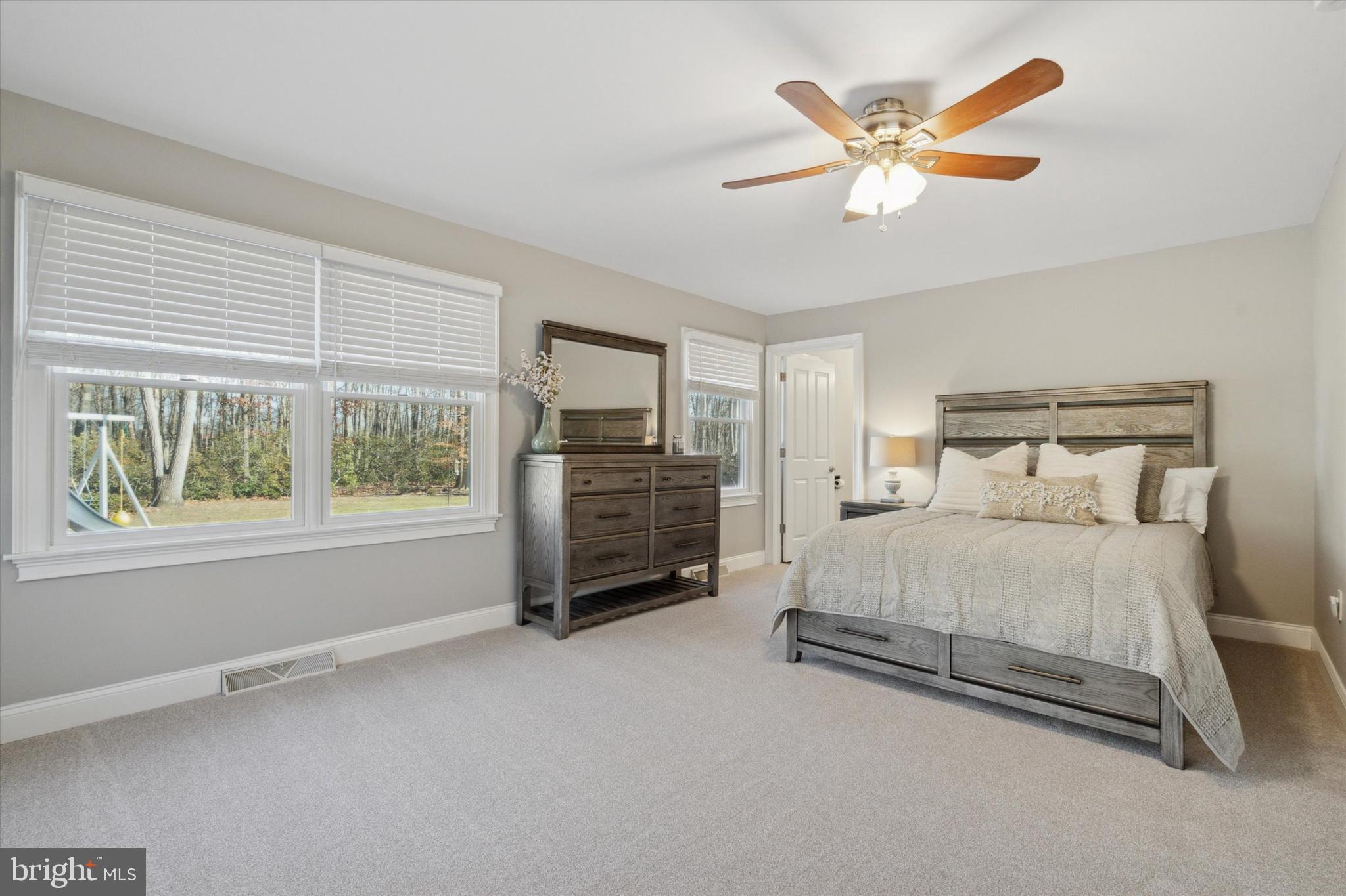 132 Hawkin Road New Egypt, NJ 08533 - Photo 23 of 42 a spacious bedroom with a bed and a large window
