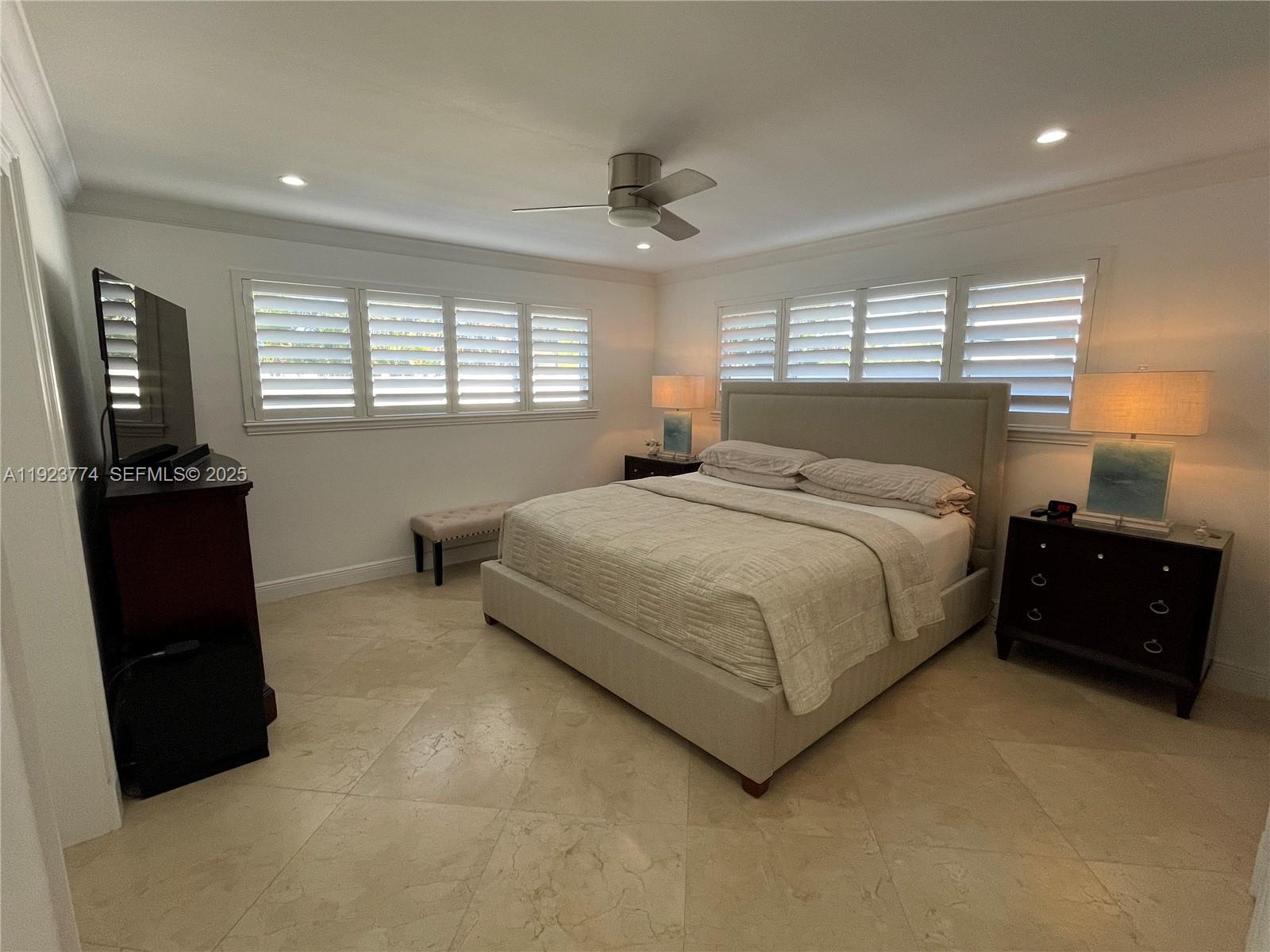 6611 Northeast 21st Lane Fort Lauderdale, FL 33308 - Photo 15 of 32 a bedroom with a bed and wooden floor