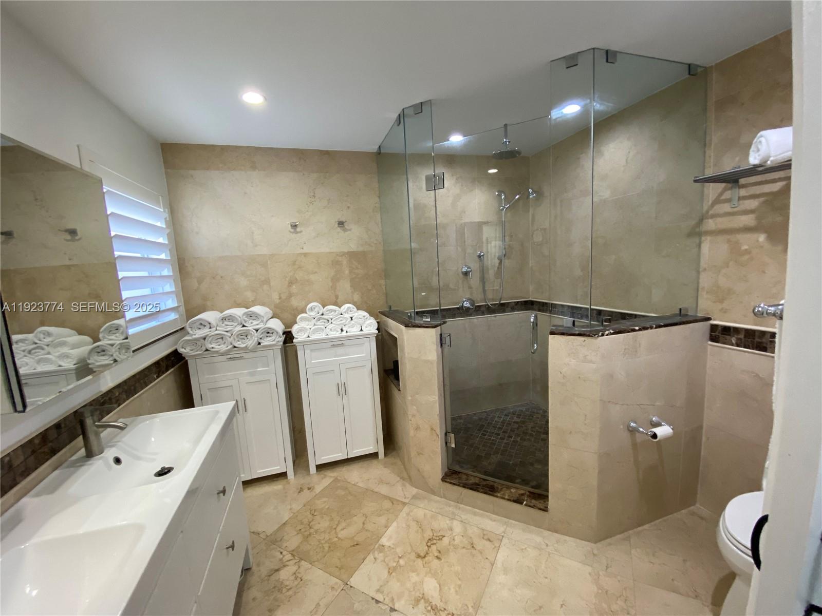 6611 Northeast 21st Lane Fort Lauderdale, FL 33308 - Photo 16 of 32 a bathroom with a tub sink and toilet