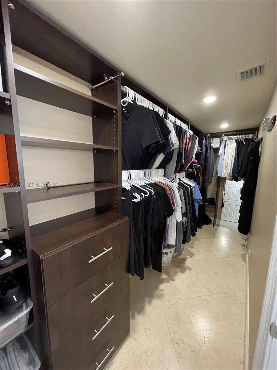 6611 Northeast 21st Lane Fort Lauderdale, FL 33308 - Photo 17 of 32 a view of walk in closet with clothes and shoes