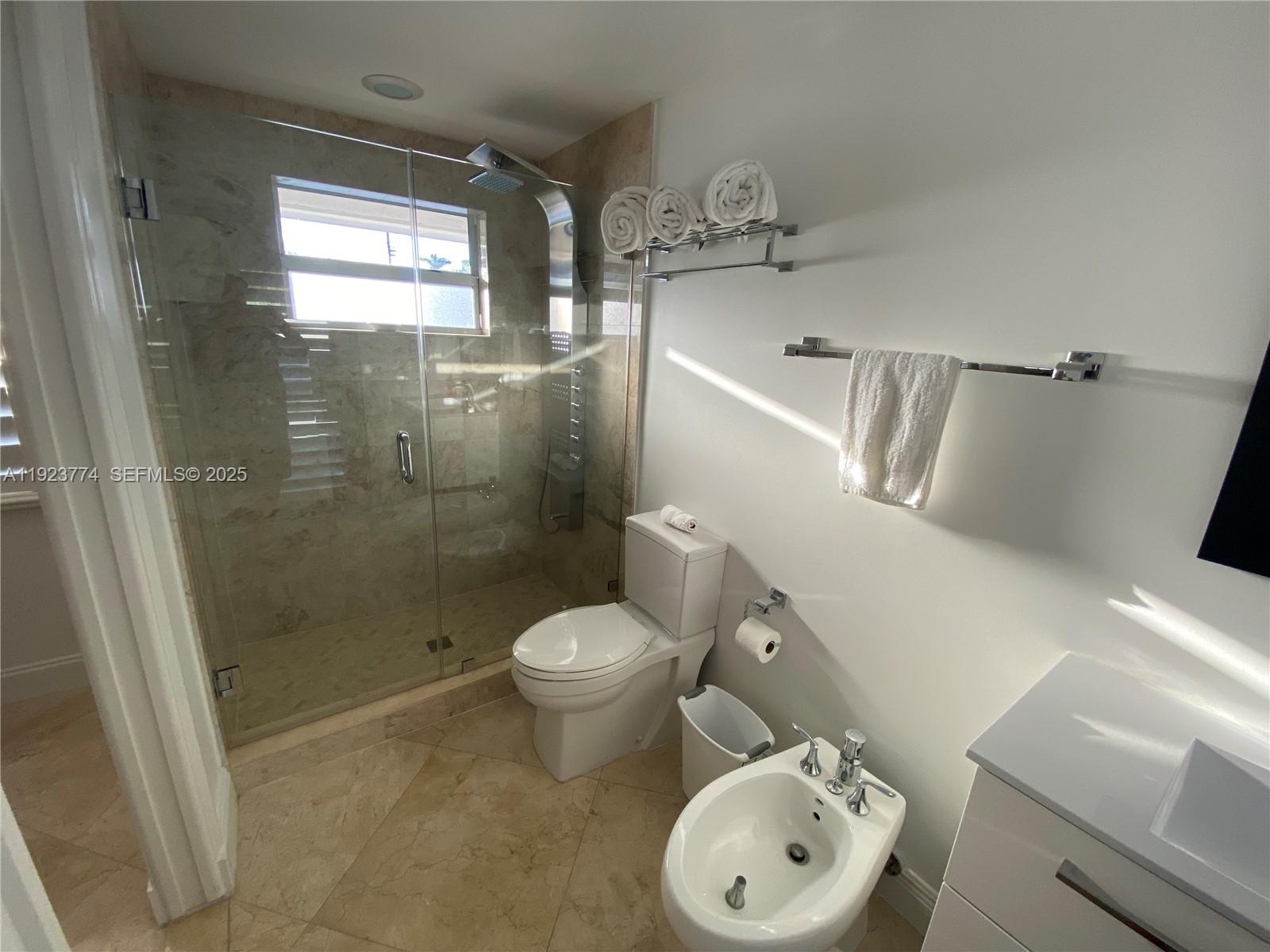 6611 Northeast 21st Lane Fort Lauderdale, FL 33308 - Photo 22 of 32 a bathroom with a toilet a sink and shower
