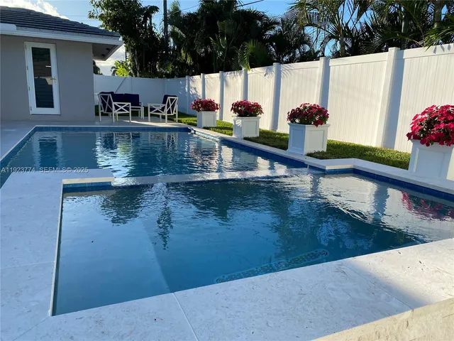 a view of backyard with outdoor seating