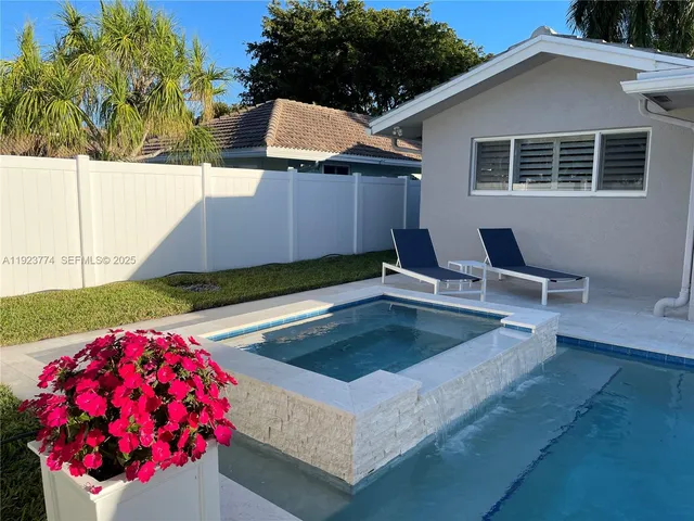 a backyard of a house with table and chairs
