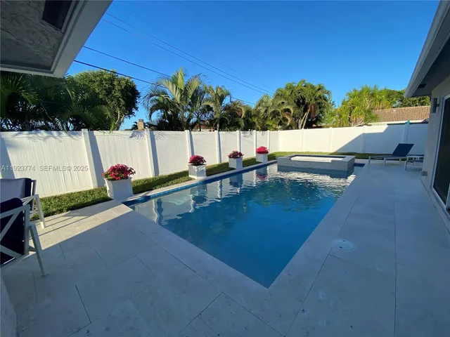 a view of a house with a backyard porch and sitting area