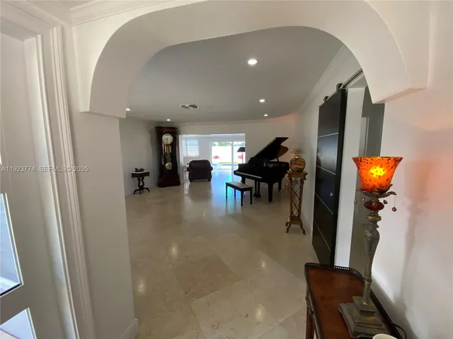 an entryway in a hall with a window