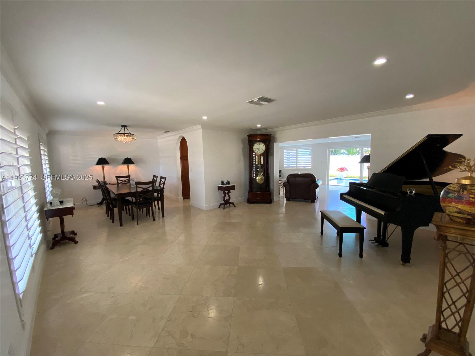 6611 Northeast 21st Lane Fort Lauderdale, FL 33308 - Photo 6 of 32 a living room with furniture and a piano