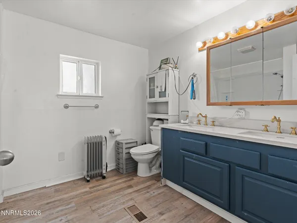 a bathroom with a toilet sink and mirror