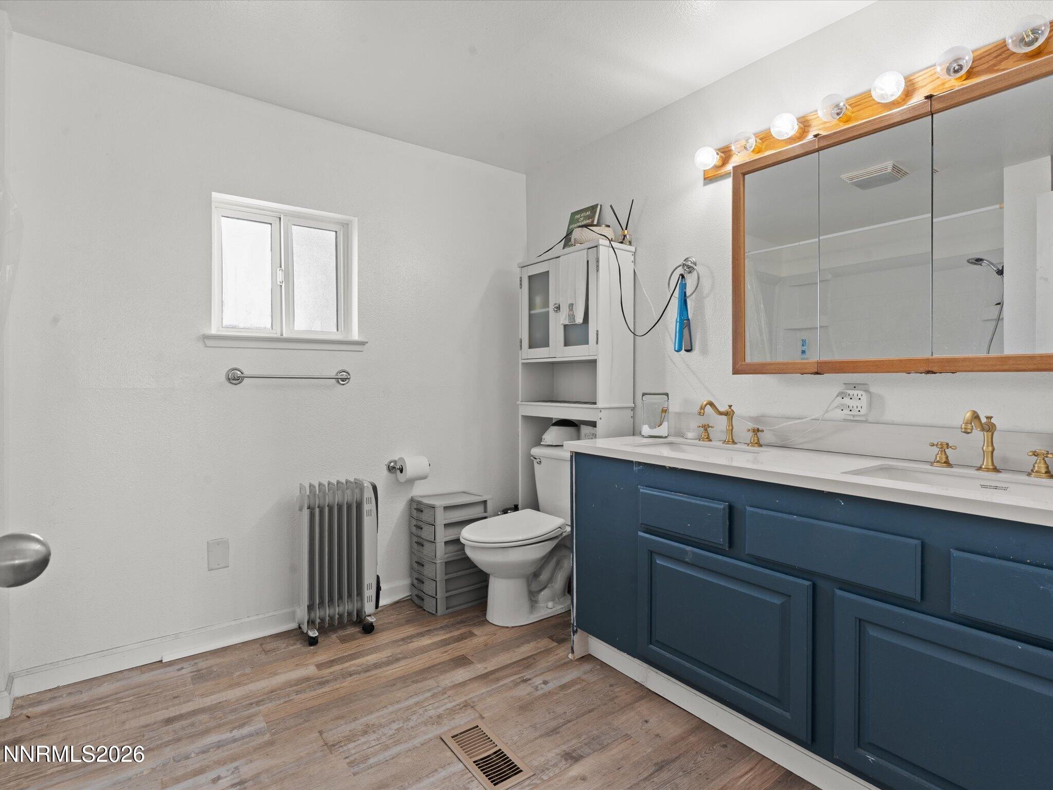 3320 Della Circle Fallon, NV 89406 - Photo 17 of 31 a bathroom with a toilet sink and mirror