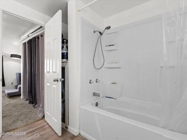 a bathroom with a bathtub with shower