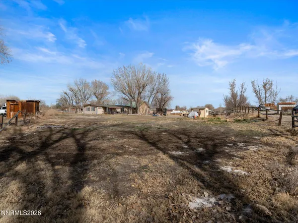 a view of dirt road with a building in the background