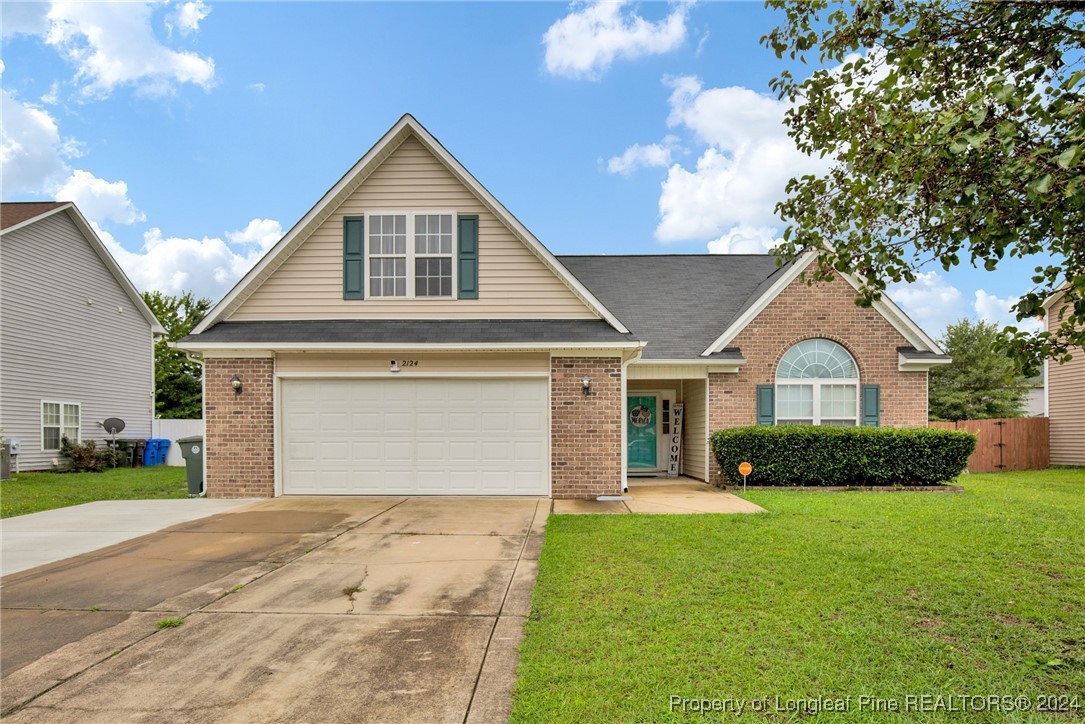 2124 Yellowbrick Road Fayetteville, NC 28314 - Photo 1 of 30 a front view of a house with a yard and garage