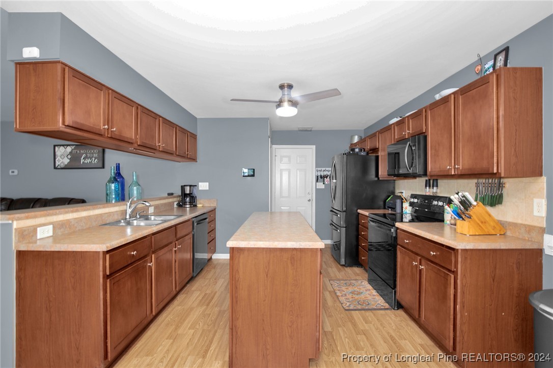 2124 Yellowbrick Road Fayetteville, NC 28314 - Photo 11 of 30 a kitchen with stainless steel appliances granite countertop a stove top oven a sink dishwasher and a refrigerator with wooden cabinets