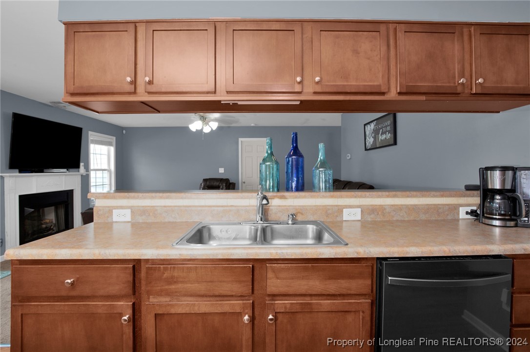 2124 Yellowbrick Road Fayetteville, NC 28314 - Photo 12 of 30 a sink with granite countertop a sink and a wooden cabinets