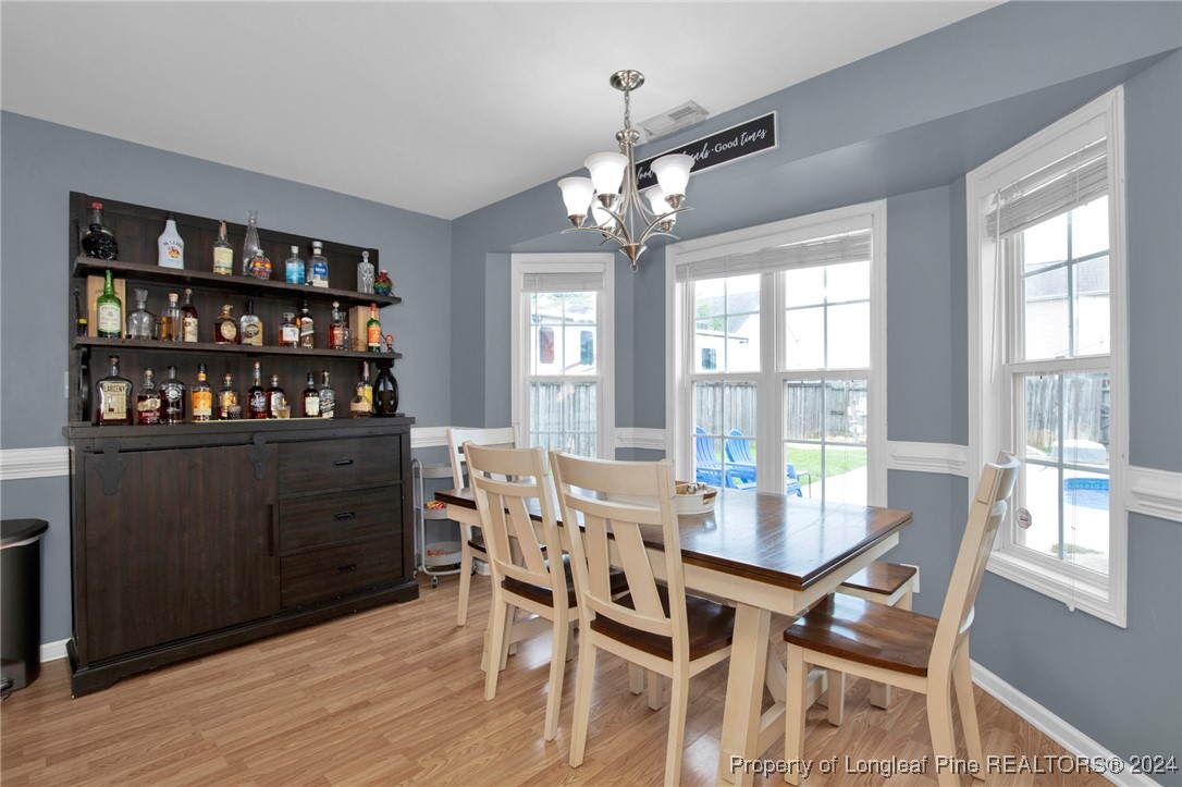 2124 Yellowbrick Road Fayetteville, NC 28314 - Photo 15 of 30 a view of a dining room with furniture window and wooden floor