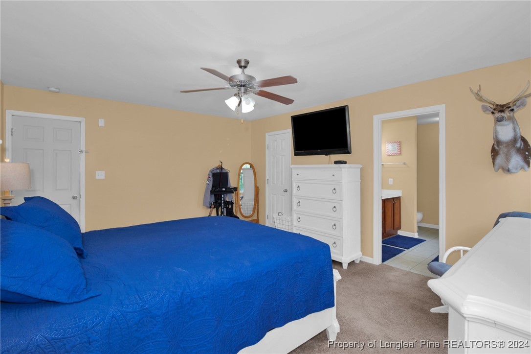2124 Yellowbrick Road Fayetteville, NC 28314 - Photo 17 of 30 a bedroom with a bed and a flat screen tv