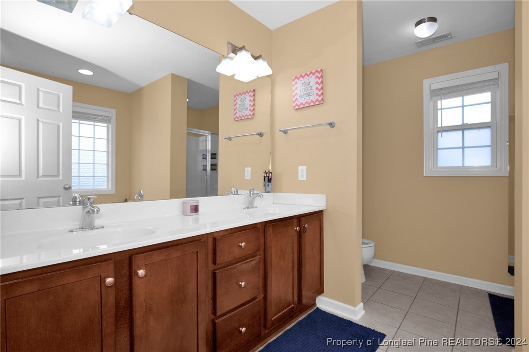 2124 Yellowbrick Road Fayetteville, NC 28314 - Photo 19 of 30 a bathroom with a sink double vanity granite and a mirror