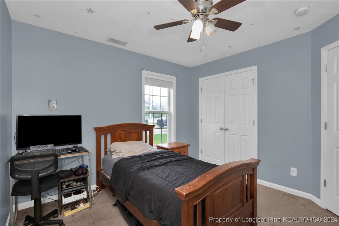 2124 Yellowbrick Road Fayetteville, NC 28314 - Photo 21 of 30 a bedroom with a bed and a flat screen tv
