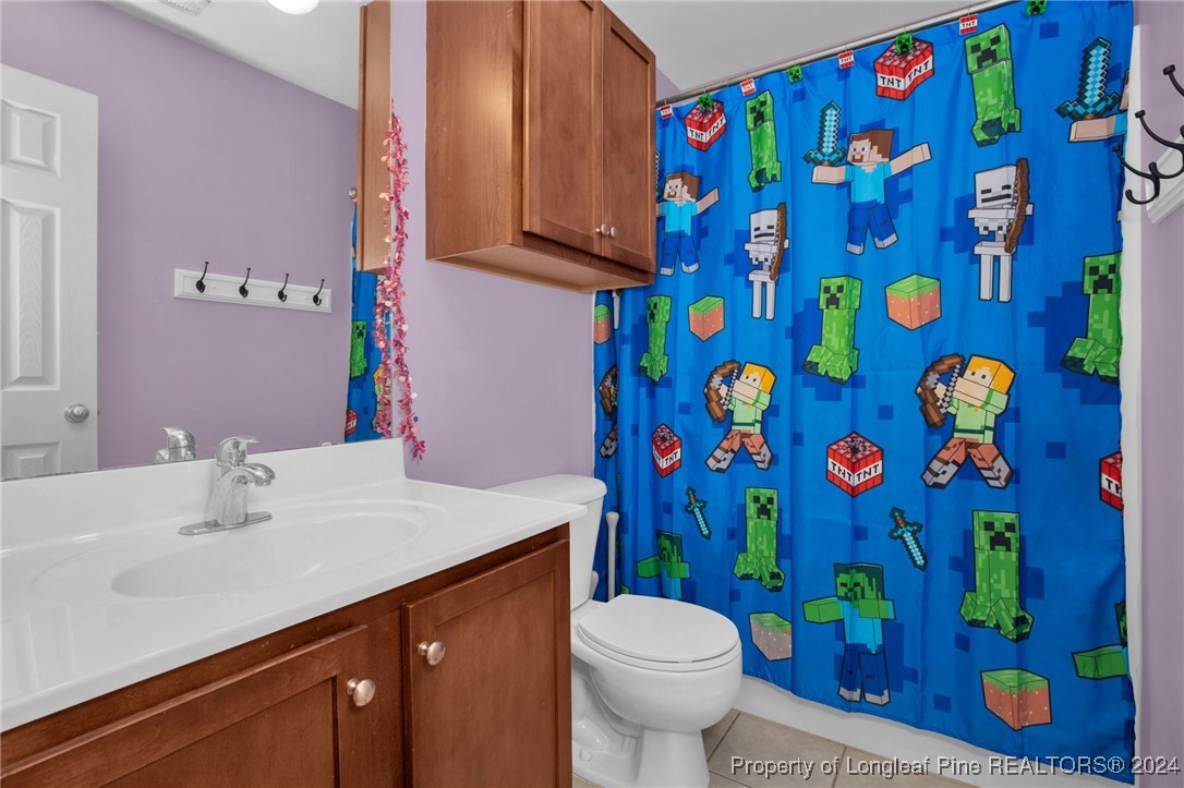 2124 Yellowbrick Road Fayetteville, NC 28314 - Photo 23 of 30 a bathroom with a sink toilet and vanity