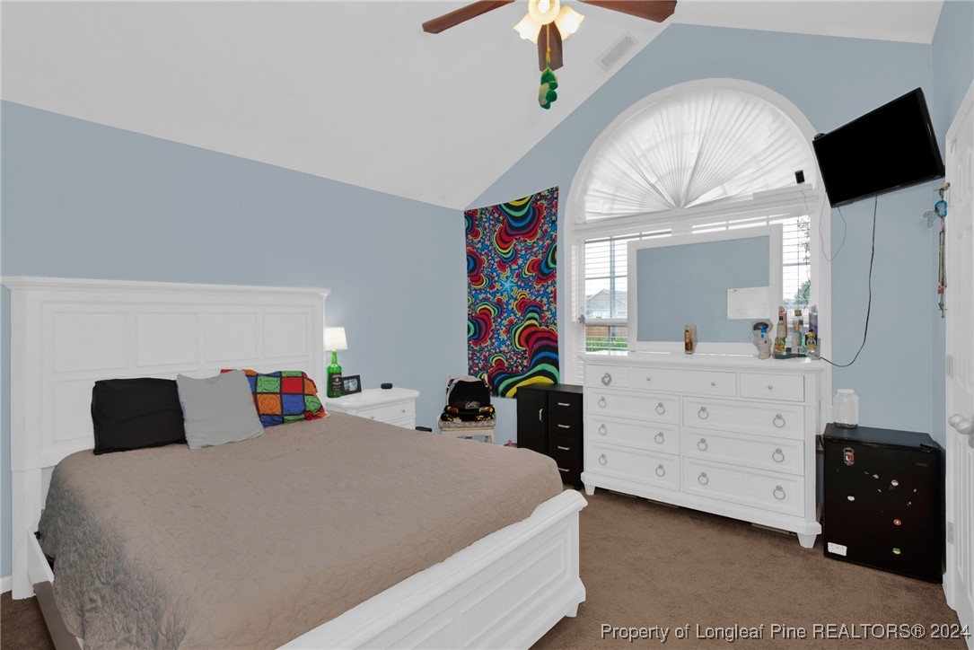 2124 Yellowbrick Road Fayetteville, NC 28314 - Photo 24 of 30 a bedroom with a bed and a chandelier