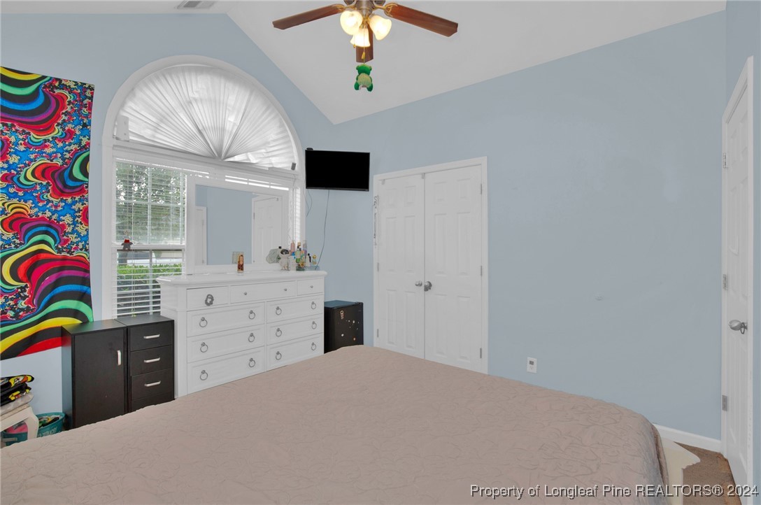 2124 Yellowbrick Road Fayetteville, NC 28314 - Photo 25 of 30 a bedroom with a bed and a chandelier