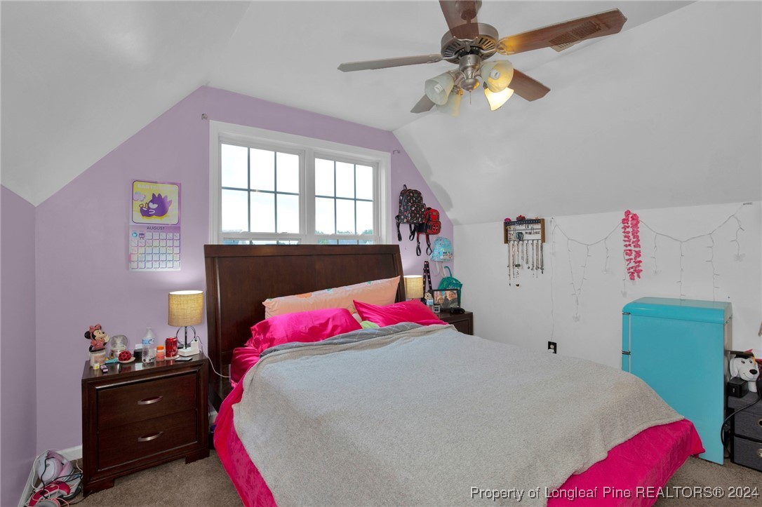 2124 Yellowbrick Road Fayetteville, NC 28314 - Photo 26 of 30 a bed room with a bed and a chandelier