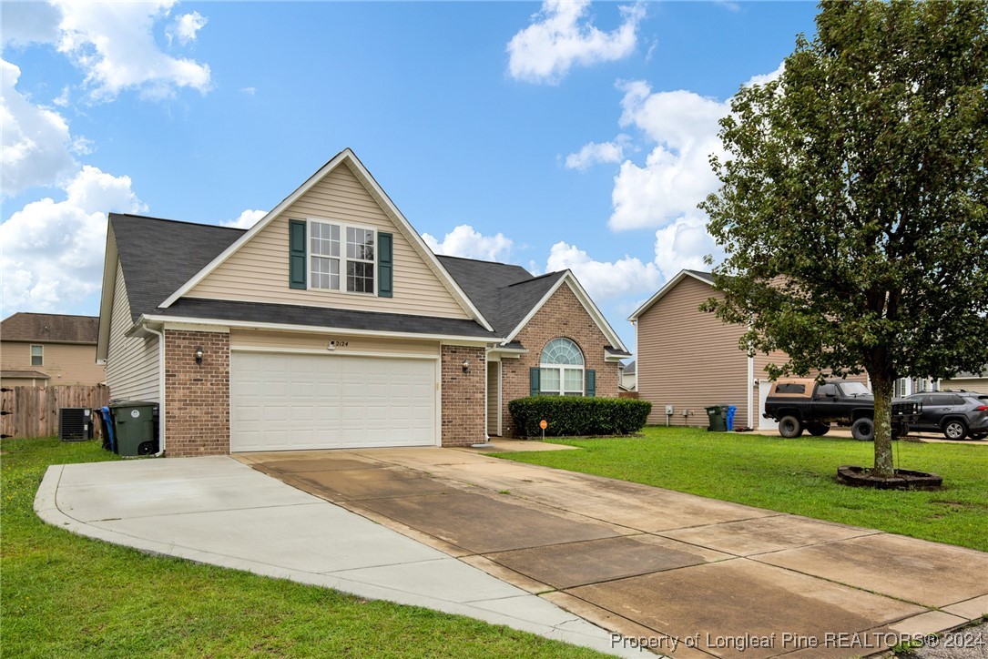 2124 Yellowbrick Road Fayetteville, NC 28314 - Photo 3 of 30 a front view of a house with a yard and trees