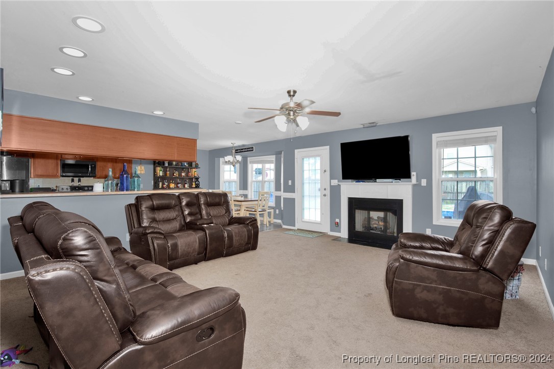 2124 Yellowbrick Road Fayetteville, NC 28314 - Photo 6 of 30 a living room with furniture a fireplace and a flat screen tv
