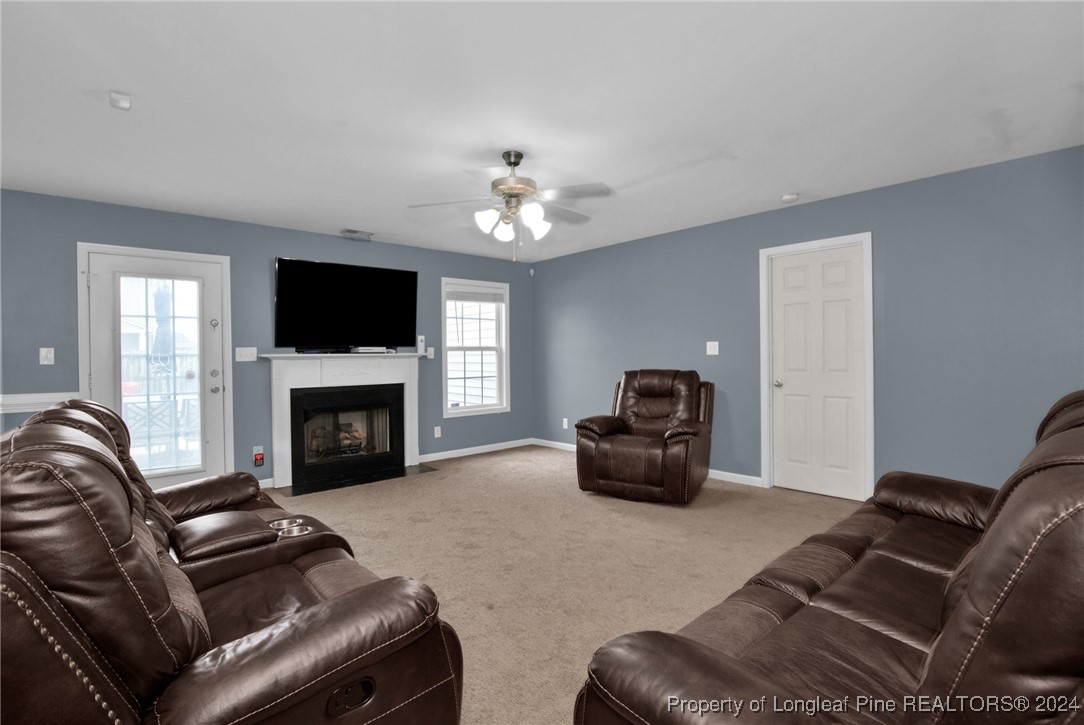 2124 Yellowbrick Road Fayetteville, NC 28314 - Photo 7 of 30 a living room with furniture a fireplace and a flat screen tv