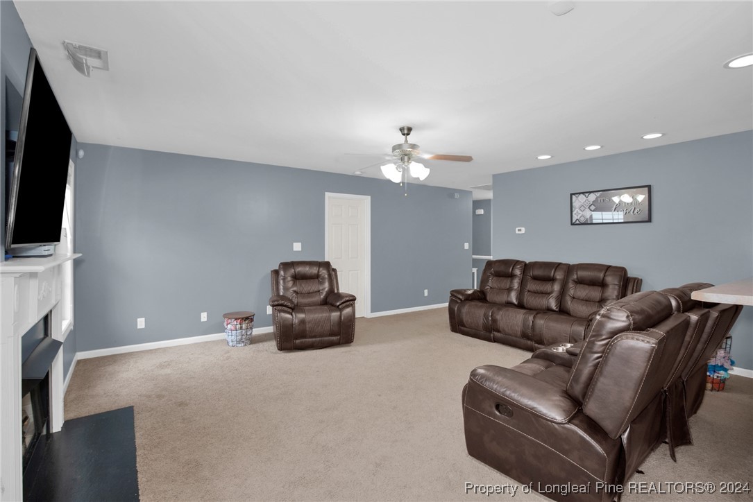 2124 Yellowbrick Road Fayetteville, NC 28314 - Photo 9 of 30 a living room with furniture and a flat screen tv