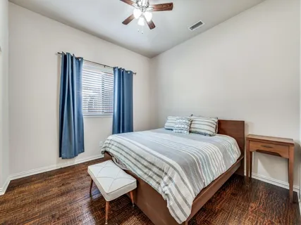 a bedroom with a bed and a dresser