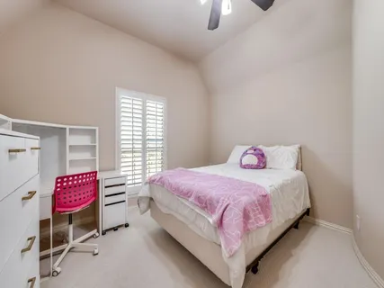 a bedroom with a bed and window